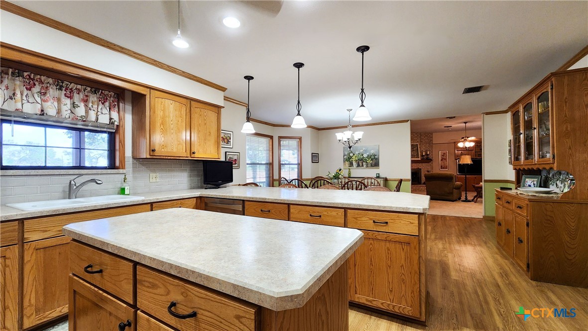 847 Oliver Road Victoria, TX 77904 - Photo 15 of 47 a kitchen with stainless steel appliances granite countertop a sink a stove and a wooden floors