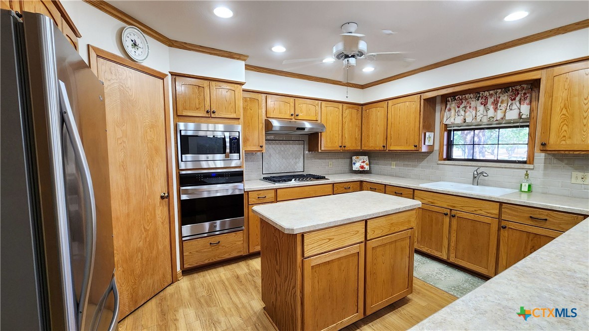 847 Oliver Road Victoria, TX 77904 - Photo 16 of 47 a kitchen with a refrigerator sink and cabinets