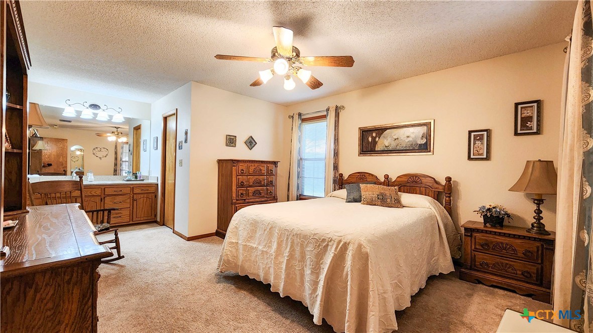 847 Oliver Road Victoria, TX 77904 - Photo 20 of 47 a spacious bedroom with a bed a dresser and potted plant