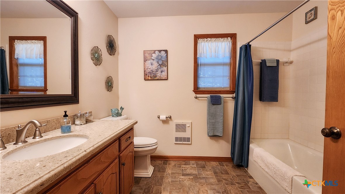 847 Oliver Road Victoria, TX 77904 - Photo 24 of 47 a bathroom with a granite countertop sink toilet and shower