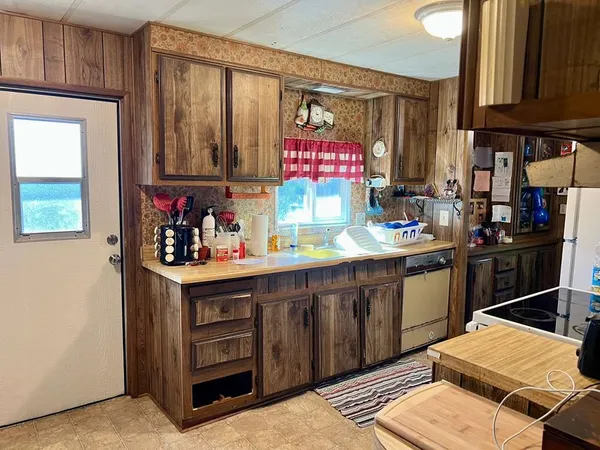 a kitchen with stainless steel appliances kitchen island granite countertop a sink and cabinets