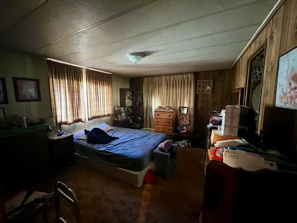 a bed room with a bed mirror and a window