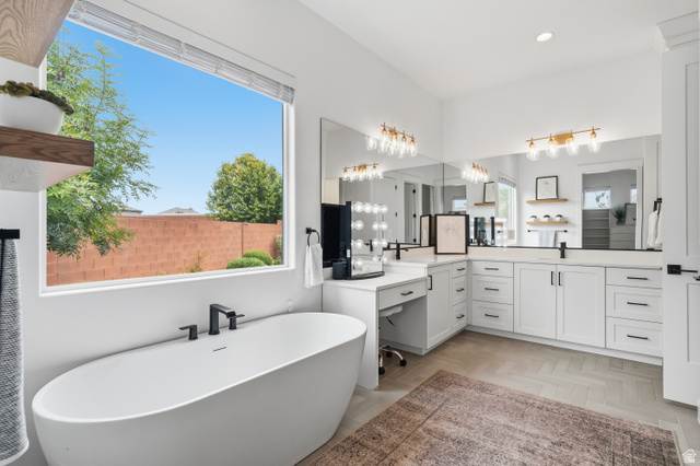 2278 Tawny Ridge Circle St. George, UT 84790 - Photo 27 of 61 Freestanding soaking tub with matte black fixtures, set against a large window.