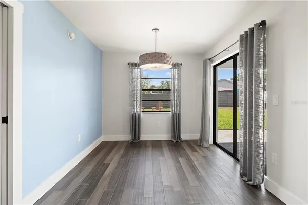 a view of a room with wooden floor staircase and windows