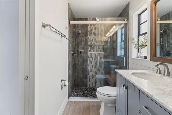 a bathroom with a sink toilet and shower