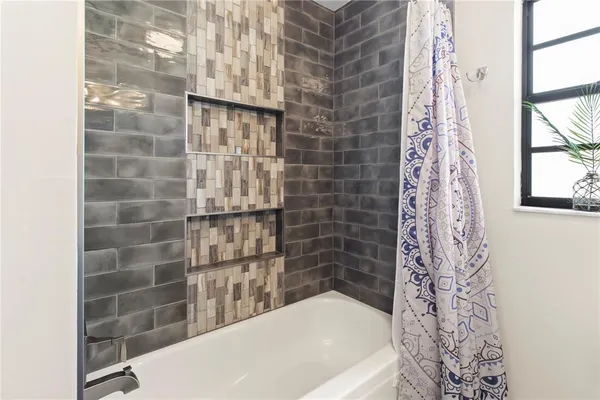 a bathroom with a bathtub and shower