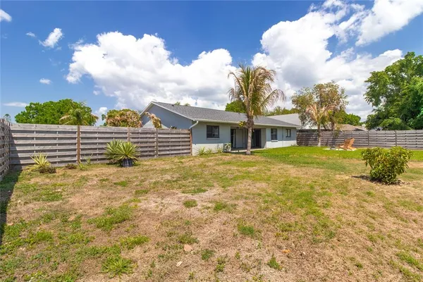 a view of house with garden space and seating area