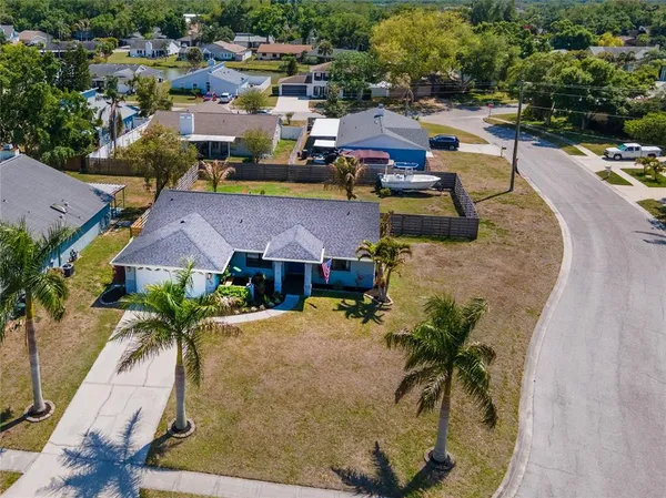 an aerial view of a house with a swimming pool and outdoor seating