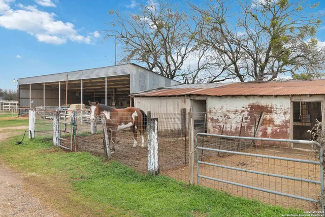 a view of a house with backyard and porch