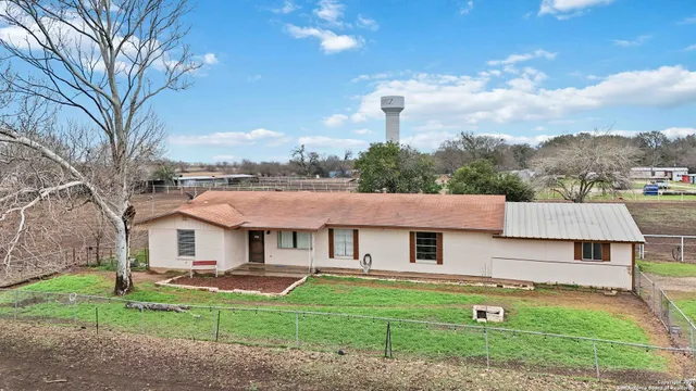 an aerial view of a house with garden space and street view