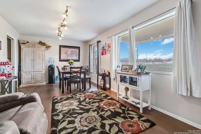 a view of a dining room with furniture and wooden floor