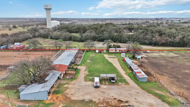 an aerial view of a house with a garden and lake view