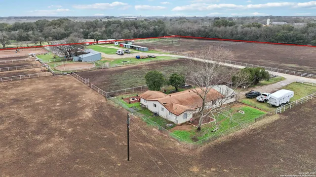 a wooden bench sitting in the middle of a rural road