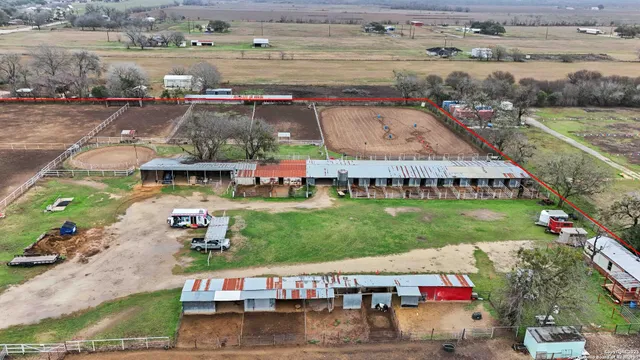 an aerial view of a house with garden space and lake view