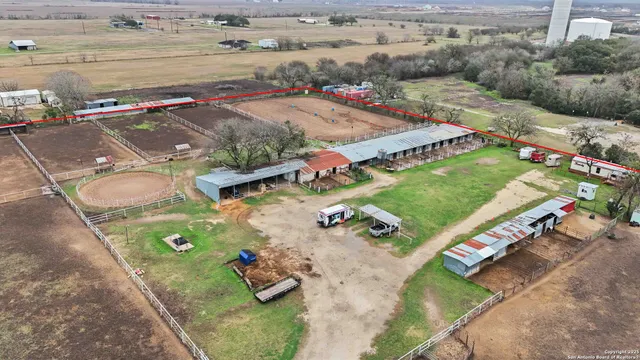 an aerial view of a pool an outdoor space and seating area