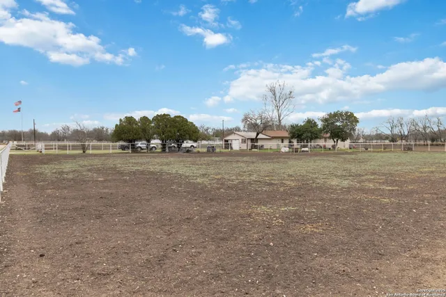 a view of a field with ocean view