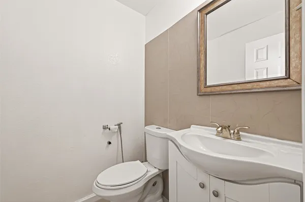 a kitchen with a refrigerator and white cabinets
