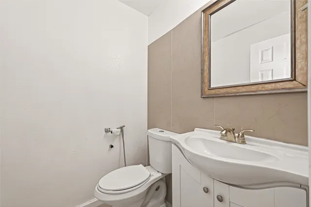 a view of a dining room with furniture a kitchen and chandelier