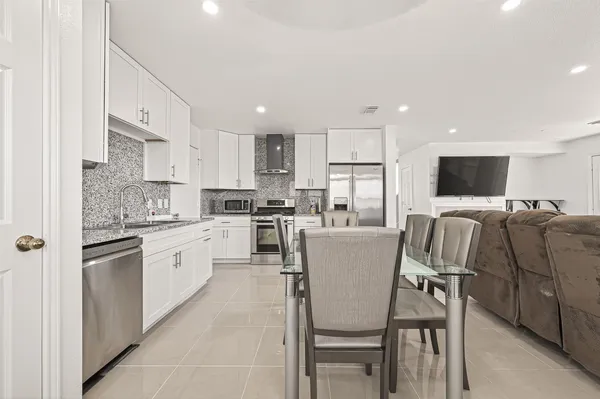 a kitchen with stainless steel appliances granite countertop a stove and a microwave