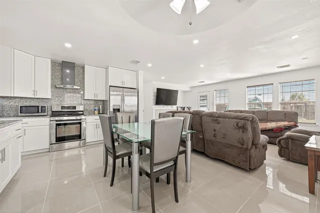 a dining room with furniture and window