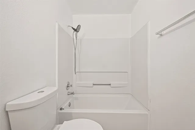 a room with a bed and a chandelier