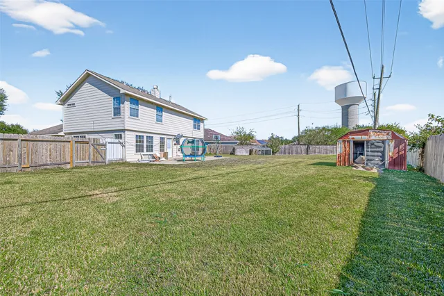 a view of a house with a backyard and a table
