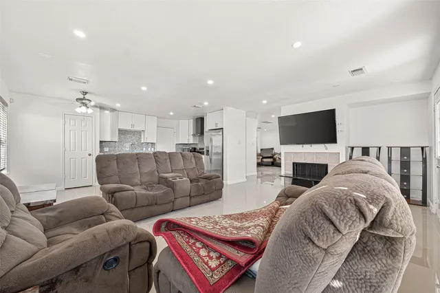 a living room with furniture fireplace and a flat screen tv