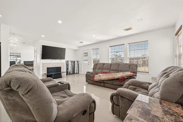 a kitchen with stainless steel appliances granite countertop a stove a sink a microwave a dining table and chairs