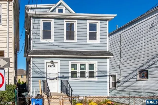 a view of a house with more windows and potted plants