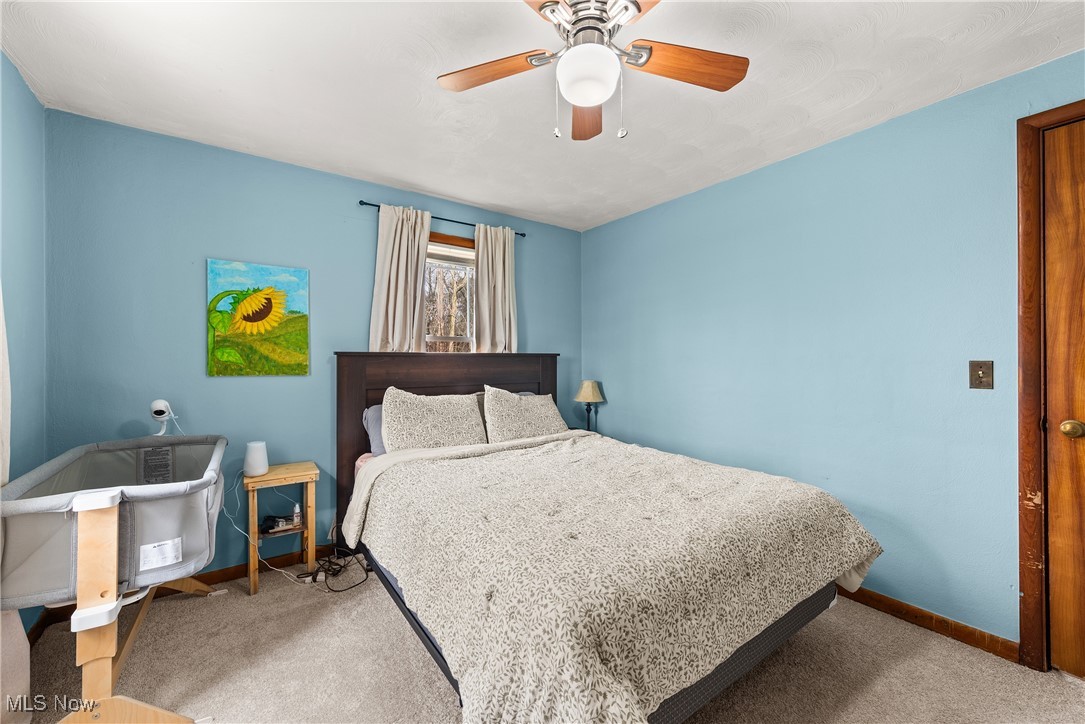 4903 Center Road Brunswick, OH 44212 - Photo 21 of 45 Bedroom with a ceiling fan, light carpet, and baseboards