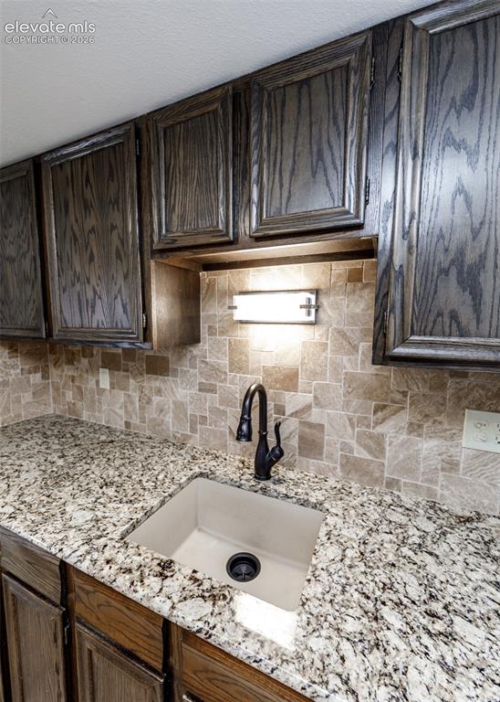 1034 Fontmore Road, Unit D Colorado Springs, CO 80904 - Photo 17 of 43 a kitchen with granite countertop a sink a stove and cabinets