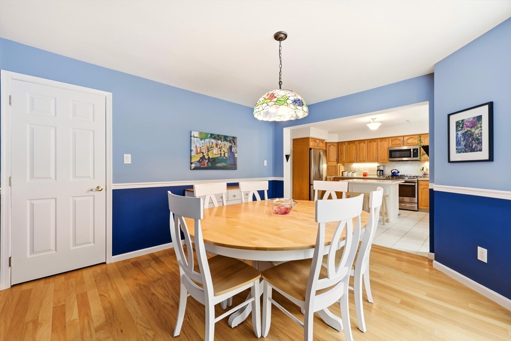 175 Leonard Street, Unit 2 Raynham, MA 02767 - Photo 11 of 27 a view of a dining room with furniture and chandelier