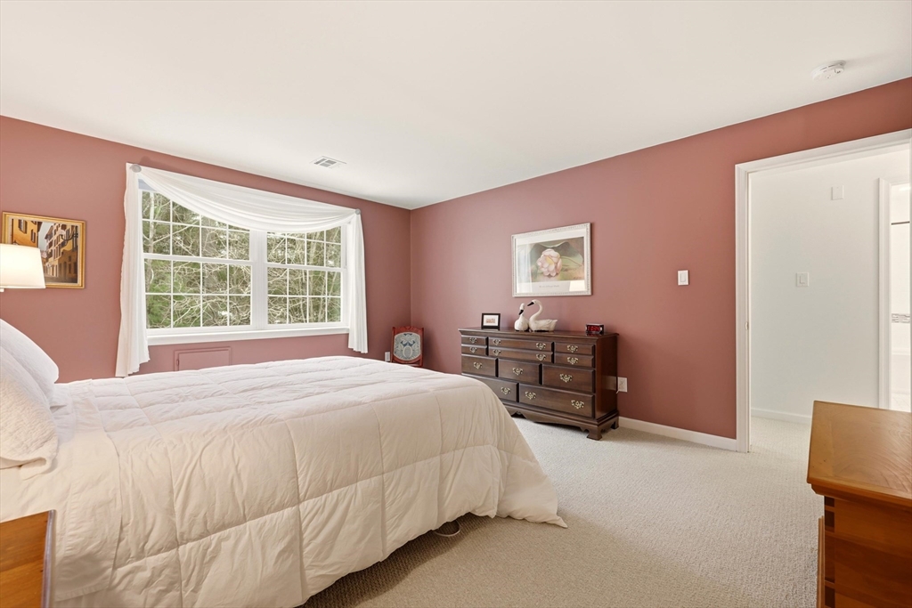 175 Leonard Street, Unit 2 Raynham, MA 02767 - Photo 14 of 27 a bedroom with a bed and a large window