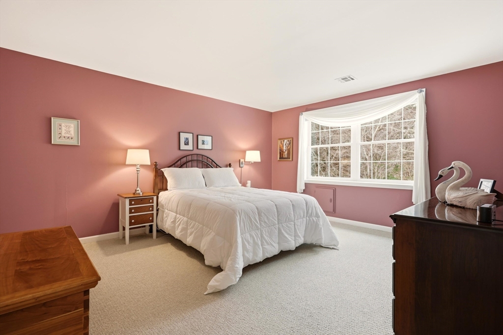 175 Leonard Street, Unit 2 Raynham, MA 02767 - Photo 15 of 27 a bedroom with a bed and a window