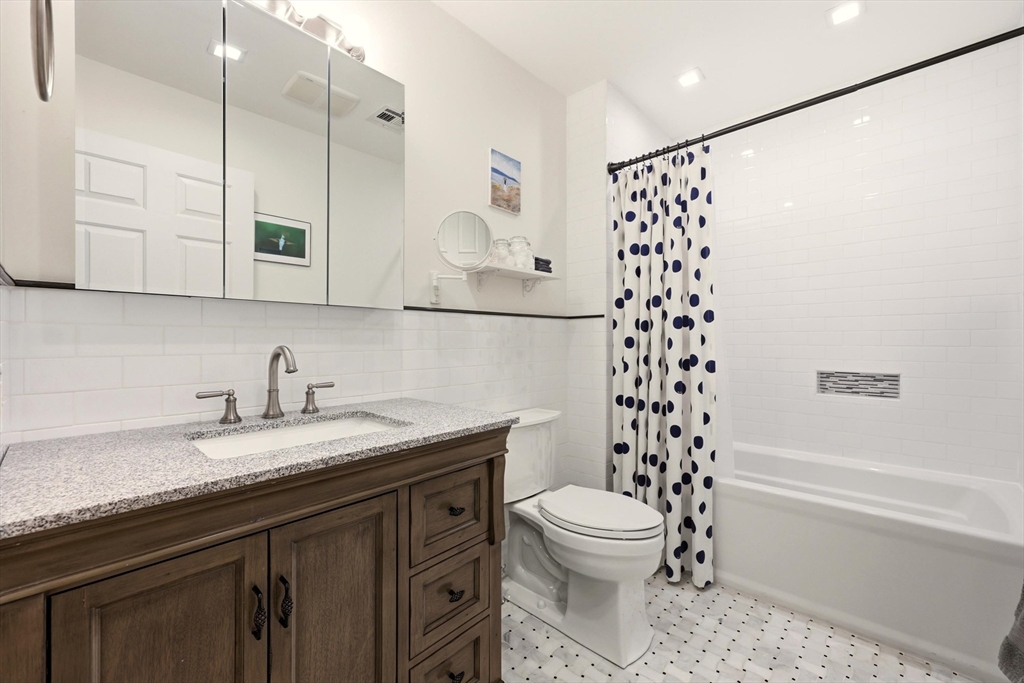 175 Leonard Street, Unit 2 Raynham, MA 02767 - Photo 17 of 27 a bathroom with a granite countertop sink toilet and shower