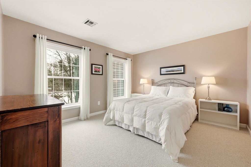 175 Leonard Street, Unit 2 Raynham, MA 02767 - Photo 18 of 27 a bedroom with a large bed and a window