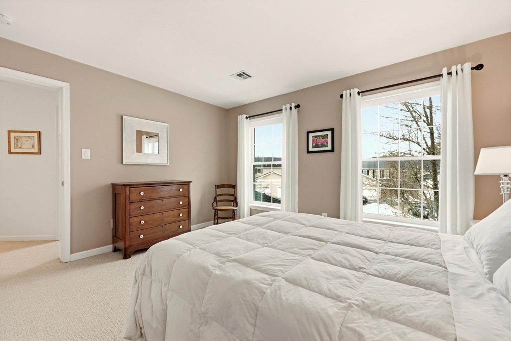 175 Leonard Street, Unit 2 Raynham, MA 02767 - Photo 20 of 27 a bedroom with a bed and a window