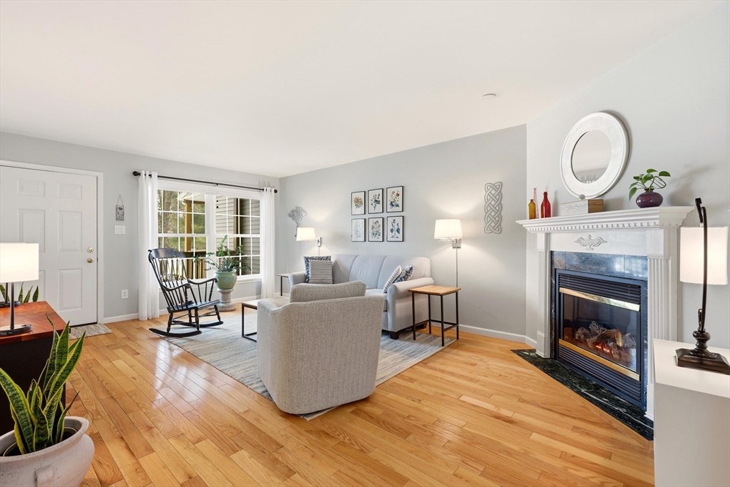 175 Leonard Street, Unit 2 Raynham, MA 02767 - Photo 3 of 27 a living room with furniture and a fireplace