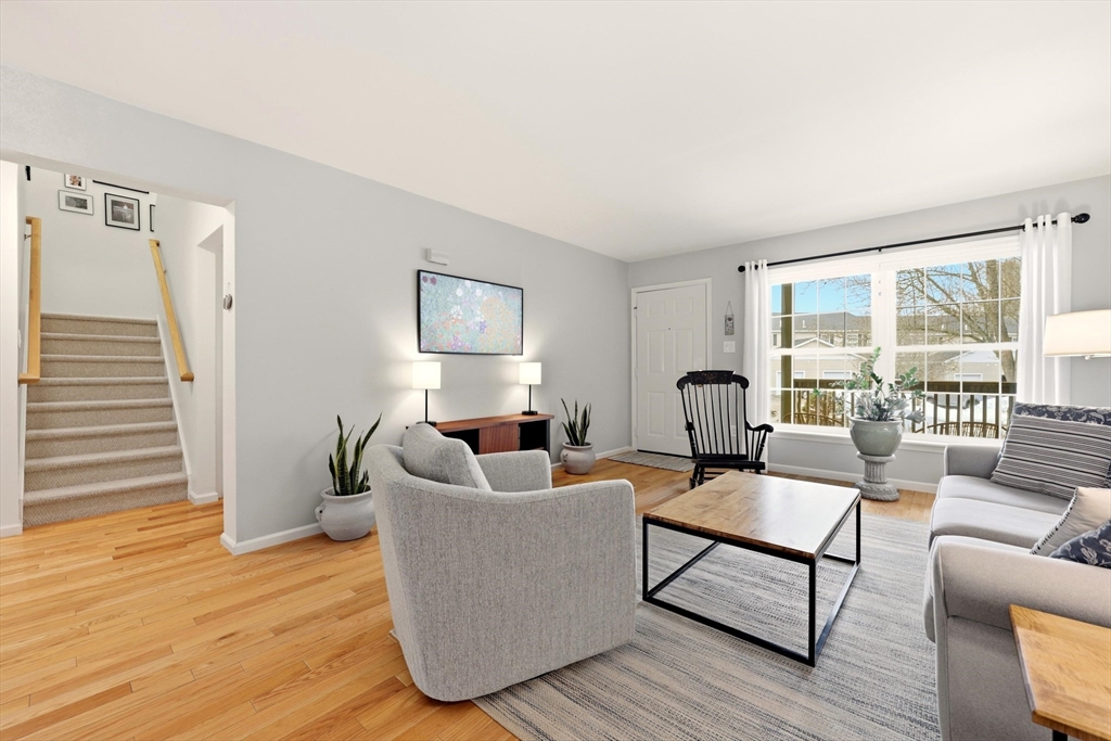 175 Leonard Street, Unit 2 Raynham, MA 02767 - Photo 4 of 27 a living room with furniture and a large window