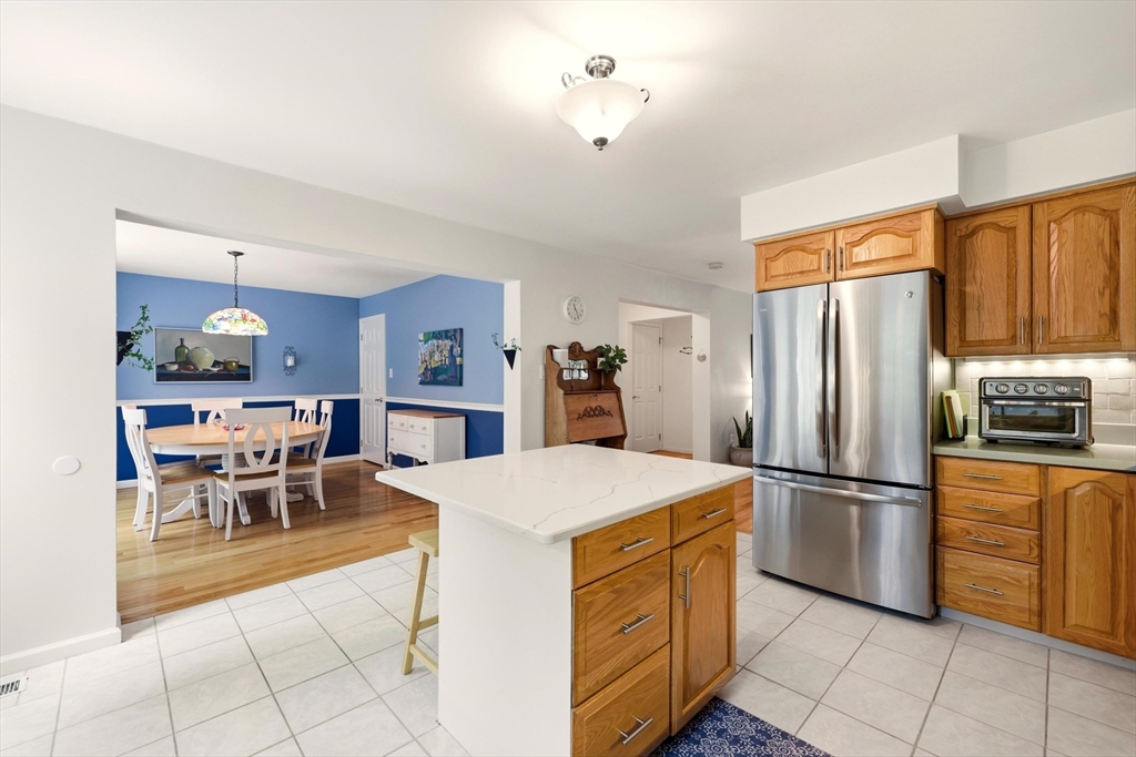 175 Leonard Street, Unit 2 Raynham, MA 02767 - Photo 8 of 27 a kitchen with stainless steel appliances a refrigerator sink and cabinets