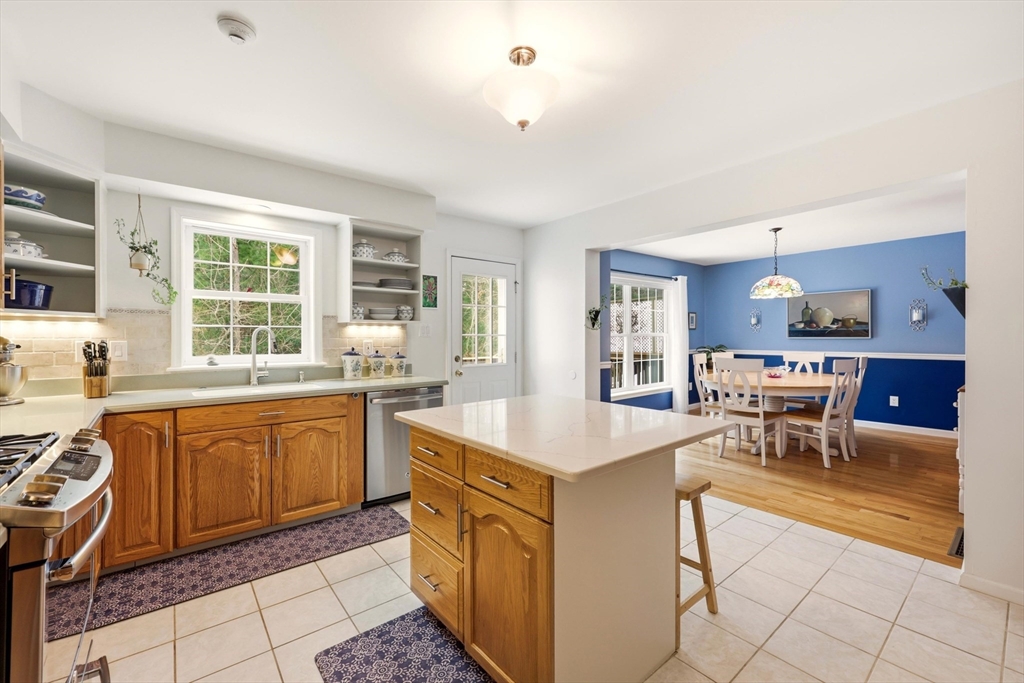 175 Leonard Street, Unit 2 Raynham, MA 02767 - Photo 9 of 27 a open kitchen with stainless steel appliances granite countertop a sink and dishwasher a refrigerator with white cabinets
