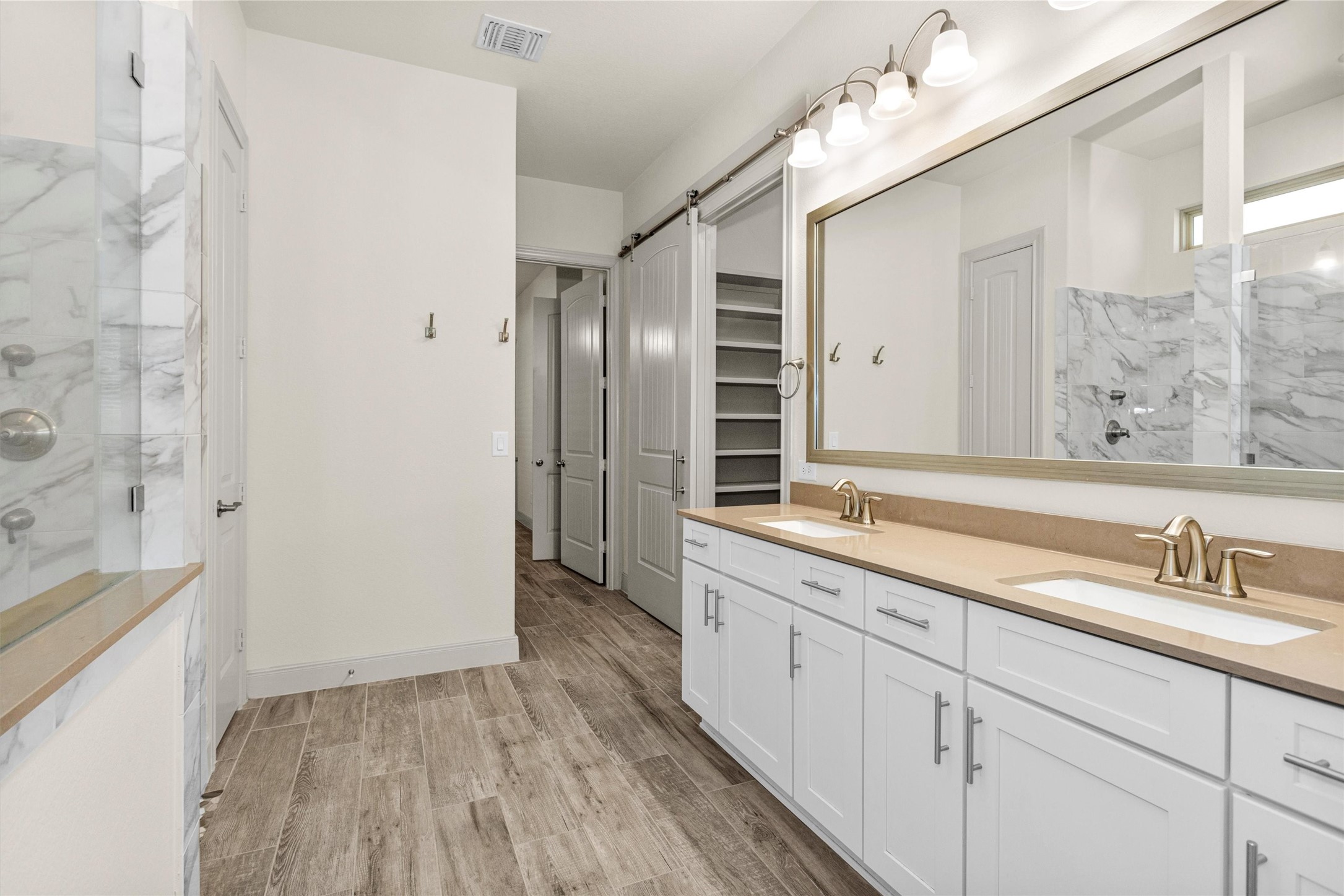 209 Fox Trotter Spring, TX 77382 - Photo 18 of 33 Owners bath is upgraded with rectangular under mount sinks, level 2 countertops, framed mirror, level 5 cabinets and linen cabinet.