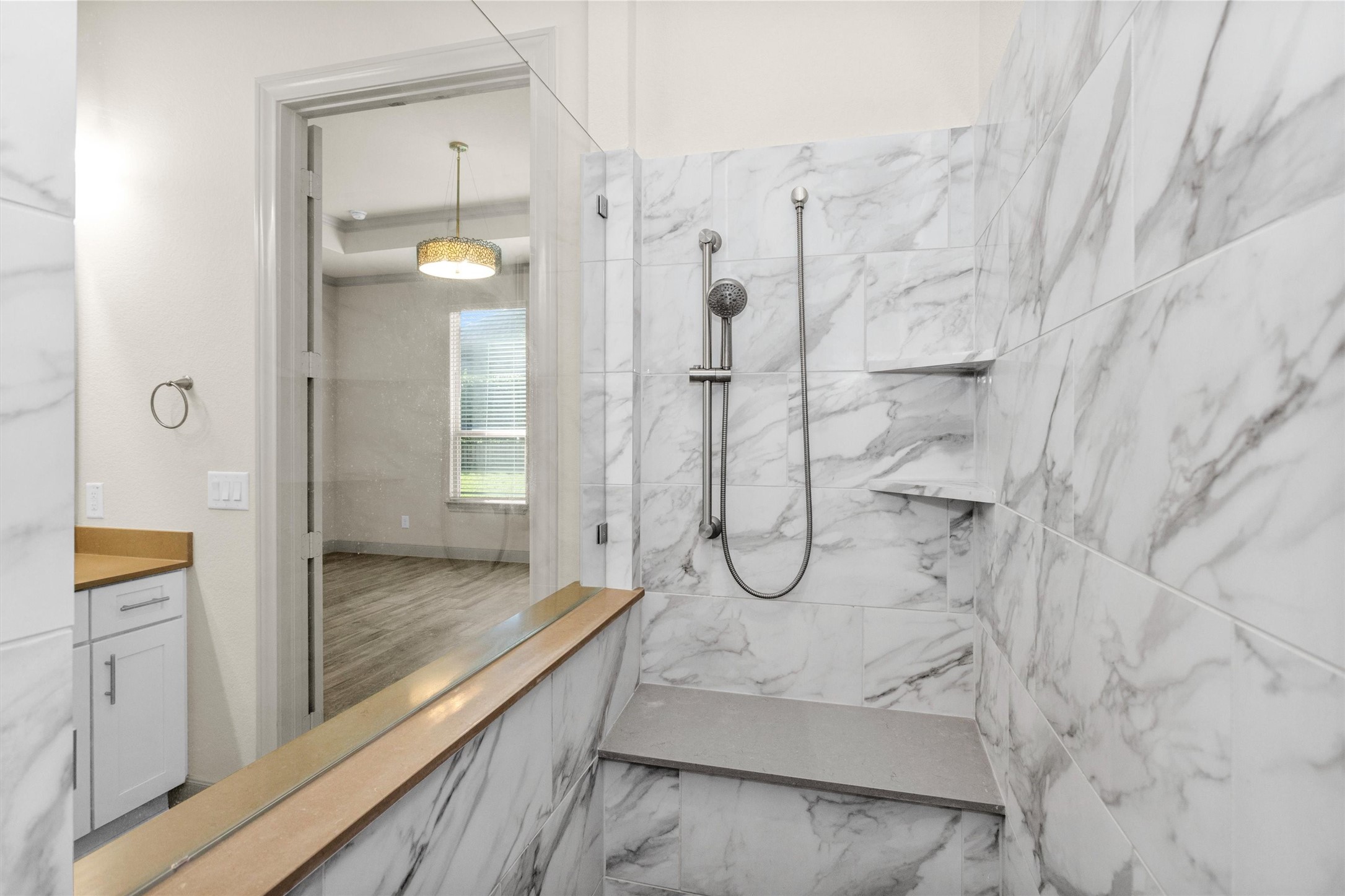 209 Fox Trotter Spring, TX 77382 - Photo 21 of 33 Indulge in the luxurious owner's spa shower, featuring a rainhead, handheld sprayer, and elegant mudset tile flooring.
