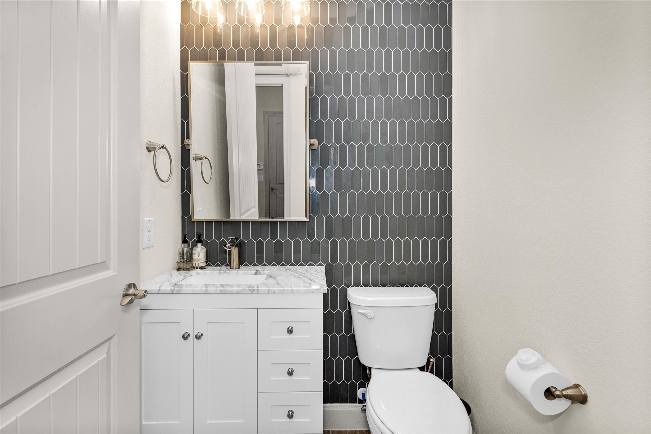 209 Fox Trotter Spring, TX 77382 - Photo 28 of 33 Elegant designer tiles, custom cabinetry, and chic lighting.