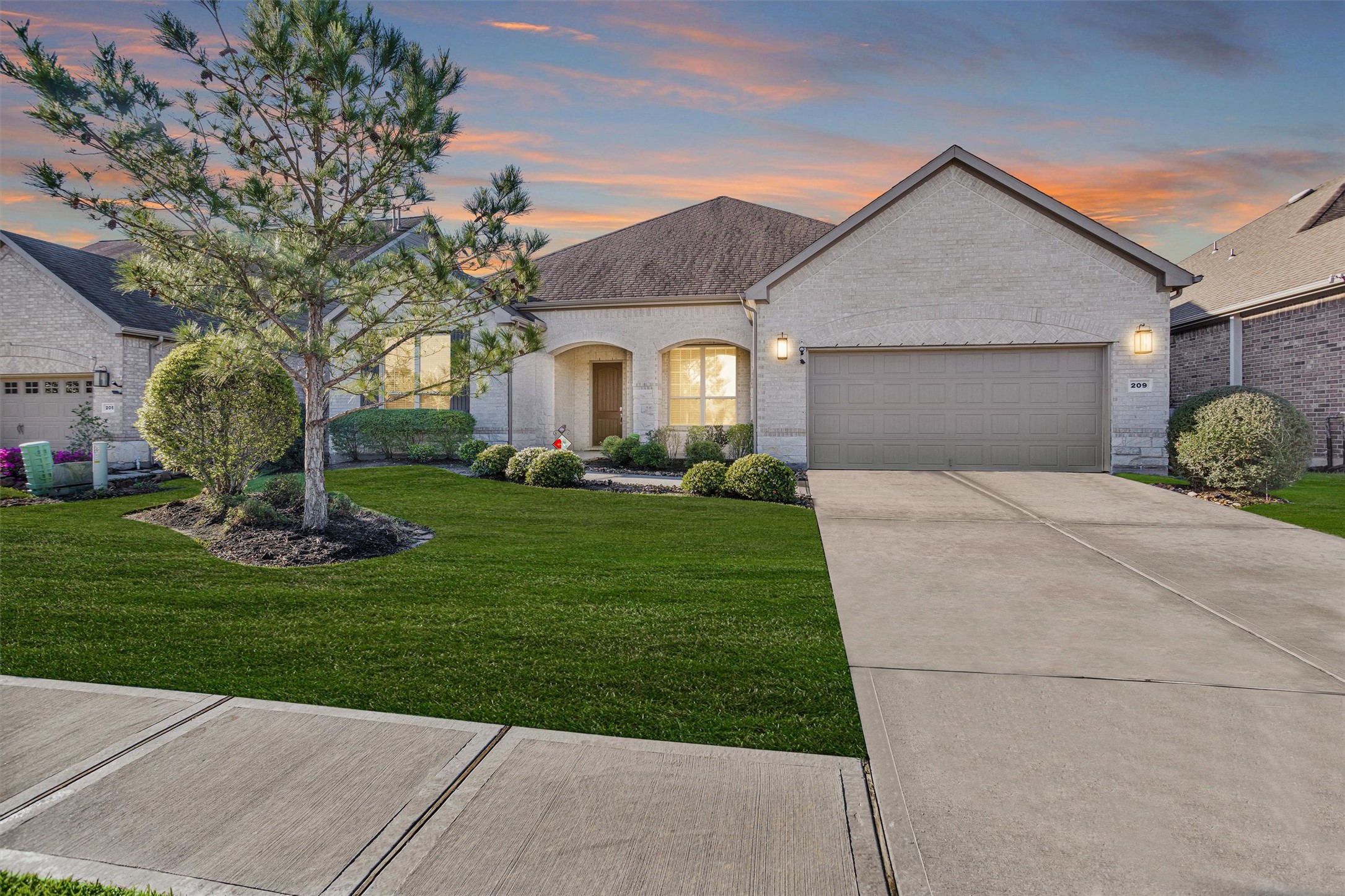209 Fox Trotter Spring, TX 77382 - Photo 3 of 33 Charming home with upgraded elevation, featuring elegant Winter Sky brick and complete gutter installation.