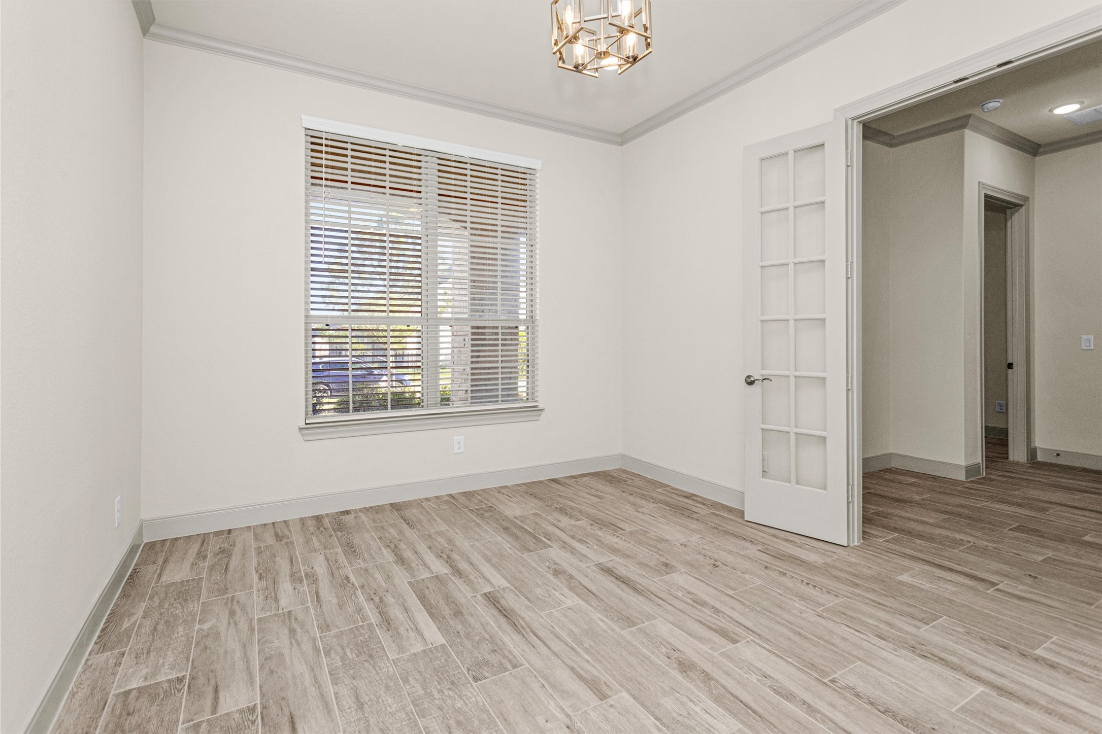 209 Fox Trotter Spring, TX 77382 - Photo 5 of 33 The study boasts a stylish light fixture and a large window with views of the covered porch.