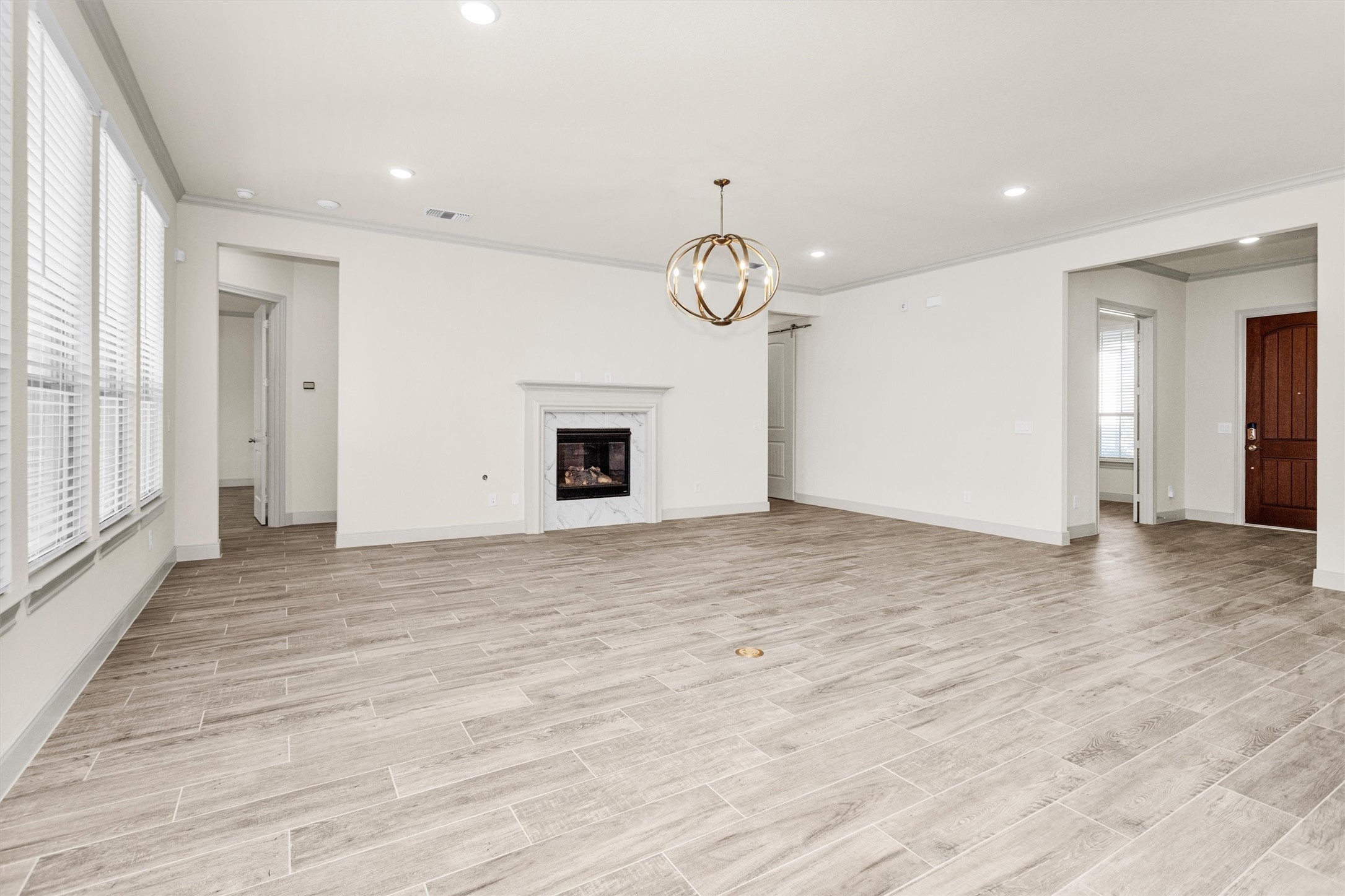 209 Fox Trotter Spring, TX 77382 - Photo 9 of 33 Spacious gathering room featuring a cozy gas fireplace.