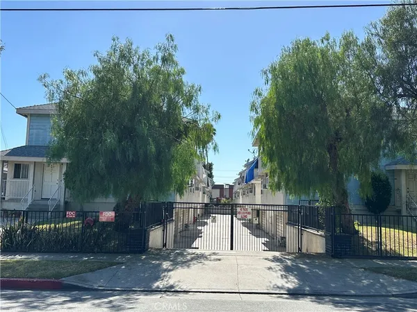 a view of a park with iron fence