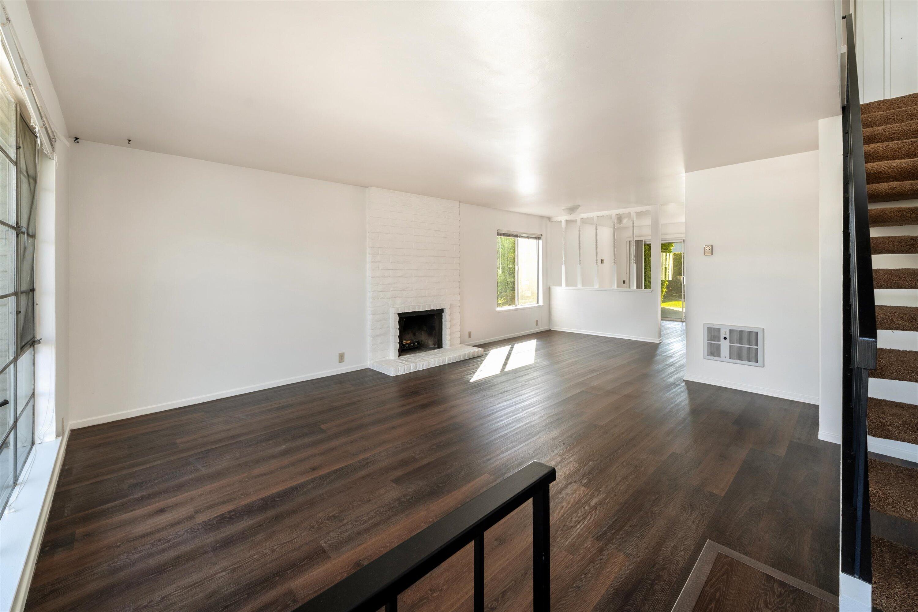 475 Linfield Place Goleta, CA 93117 - Photo 3 of 25 an empty room with wooden floor and windows