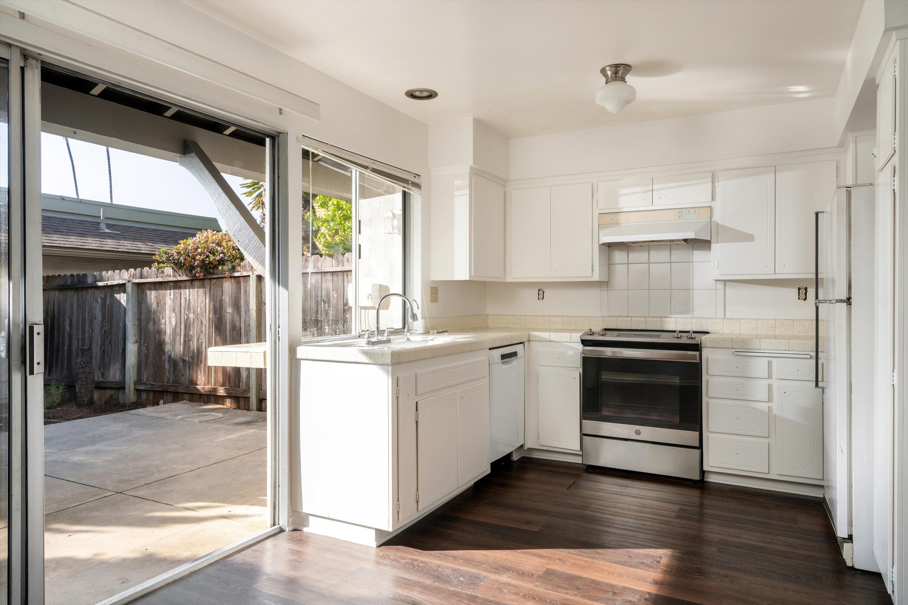 475 Linfield Place Goleta, CA 93117 - Photo 6 of 25 a kitchen with a stove a sink and a refrigerator